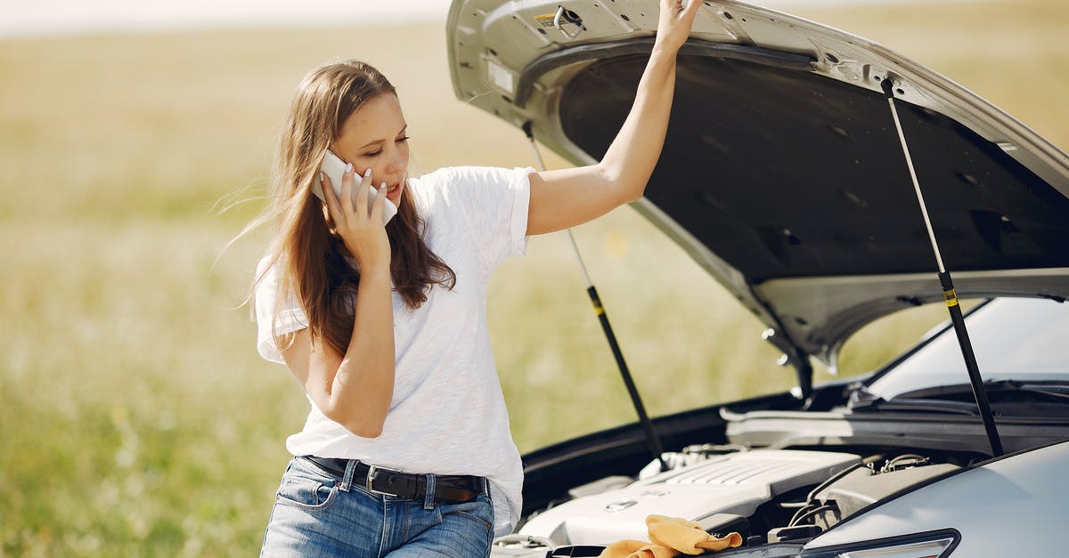 Can you get a gate pass at LAX to help someone who doesn't speak English? - Upset woman using smartphone near broken automobile in countryside during car trip Can you get a gate pass at LAX to help someone who doesn't speak English? - Upset woman using smartphone near broken automobile in countryside during car trip