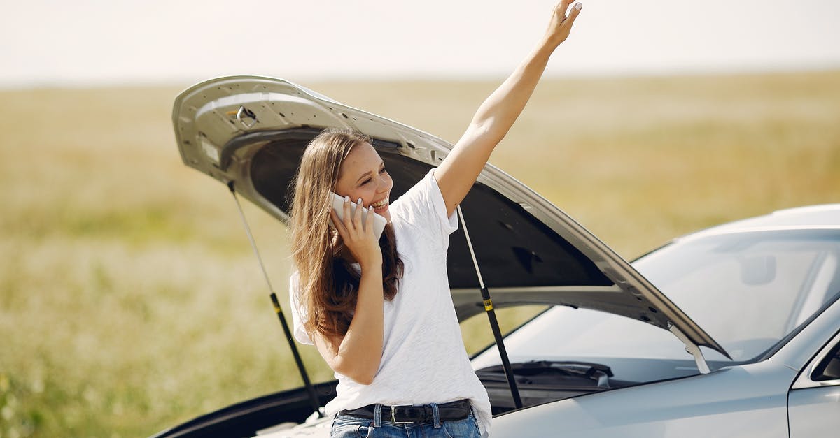 Can you get a gate pass at LAX to help someone who doesn't speak English? - Cheerful young female driver in white t shirt and jeans speaking on phone and looking away with smile while leaning on broken car with open hood and showing greeting gesture with raised hand Can you get a gate pass at LAX to help someone who doesn't speak English? - Cheerful young female driver in white t shirt and jeans speaking on phone and looking away with smile while leaning on broken car with open hood and showing greeting gesture with raised hand