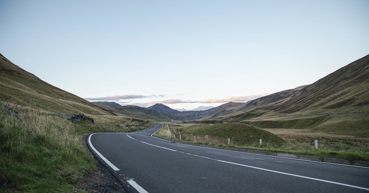 Can you land your private helicopter on Viking Line cruise ships? - Empty winding asphalt roadway running through grassy hills towards mountain range under blue sky