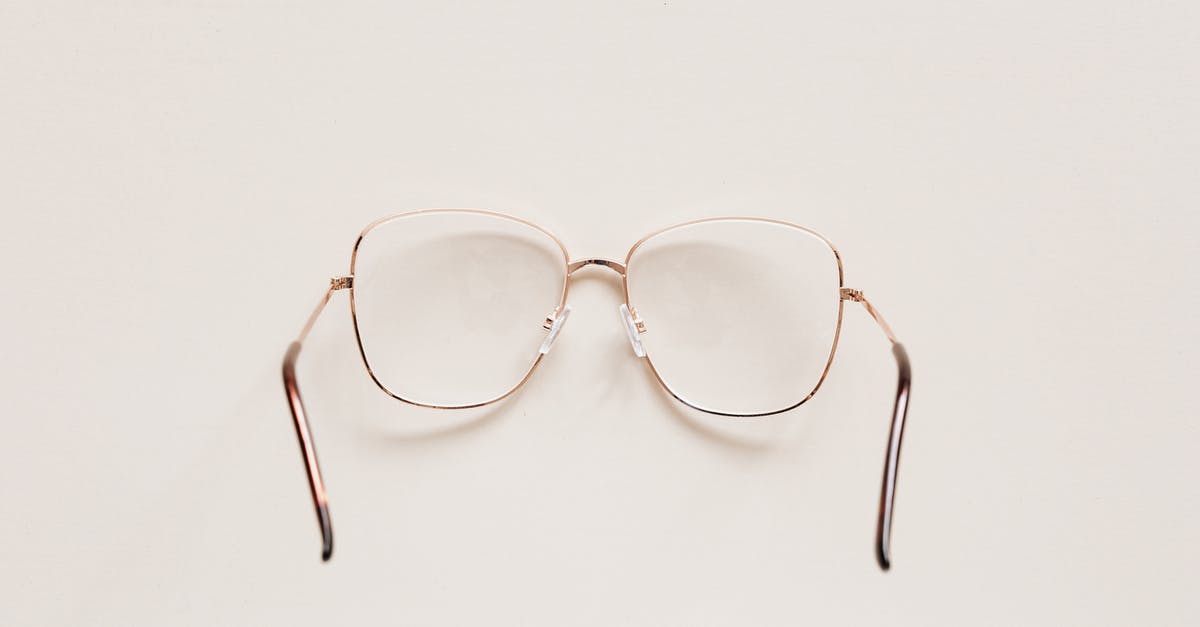 Can you see the Isles of Scilly from Cornwall? - Top view of fashion spectacles with transparent optical lenses in golden metal shell placed on white table