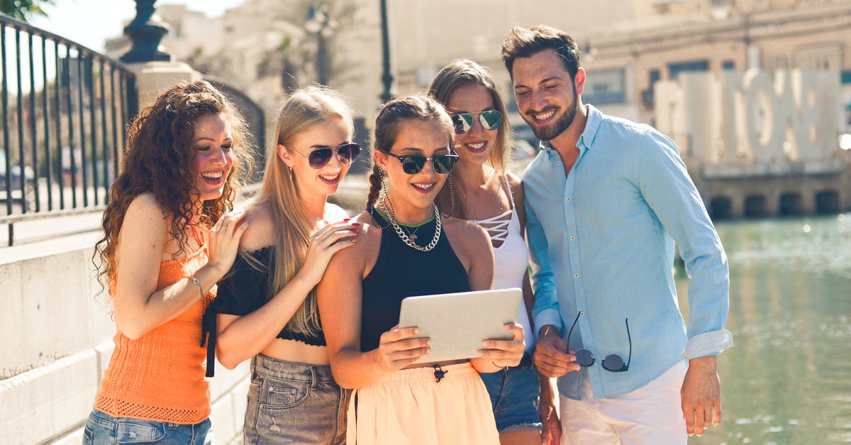 Can you share frequent flyer status with people in your travel group? - Group of People Standing Beside Body of Water Can you share frequent flyer status with people in your travel group? - Group of People Standing Beside Body of Water
