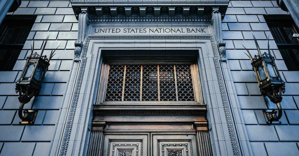 Can you sightsee in Portland, Oregon without a car? - From below classic styled historic building of United States National Bank with wooden doors and vintage lanterns located in Portland