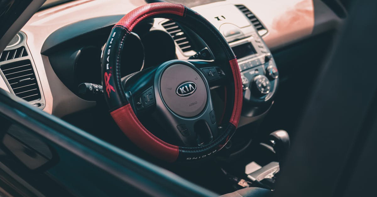 Can you travel 'above' the control of a country? - From above of contemporary design car interior with colorful steering wheel and radio with buttons