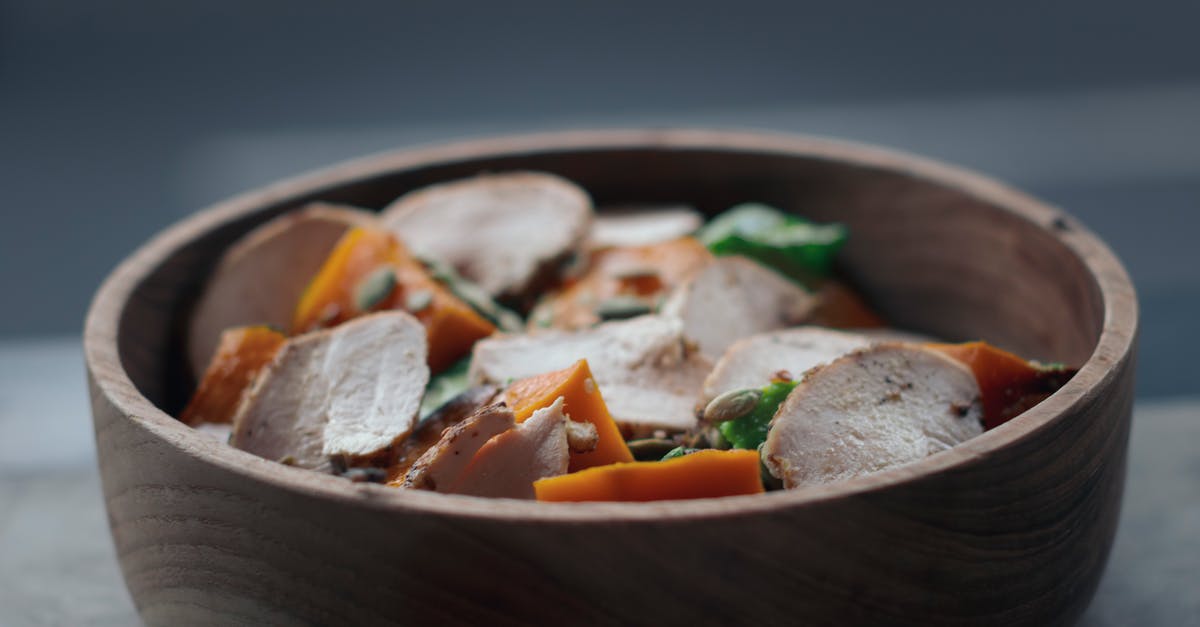 Canada - cooked chicken from abroad for personal consumption - From above of appetizing salad with thin chicken slices and vegetables in wooden bowl on table