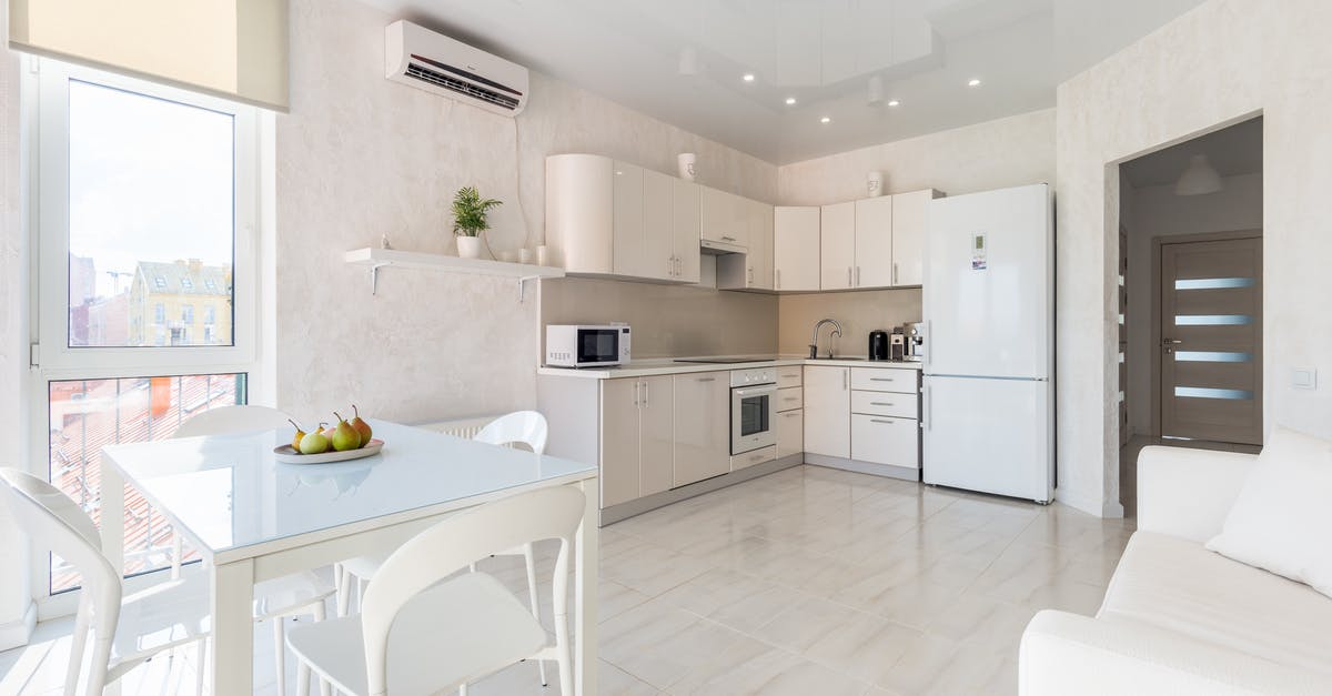 Canada: Entry by Air - Interior of spacious light kitchen with dining zone