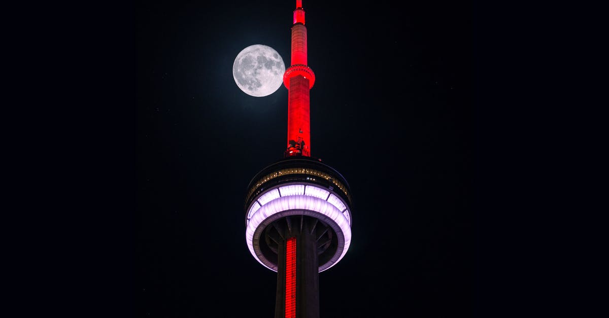 Canada Low Cost Airline - Low-angle Photography of Red and White Tower