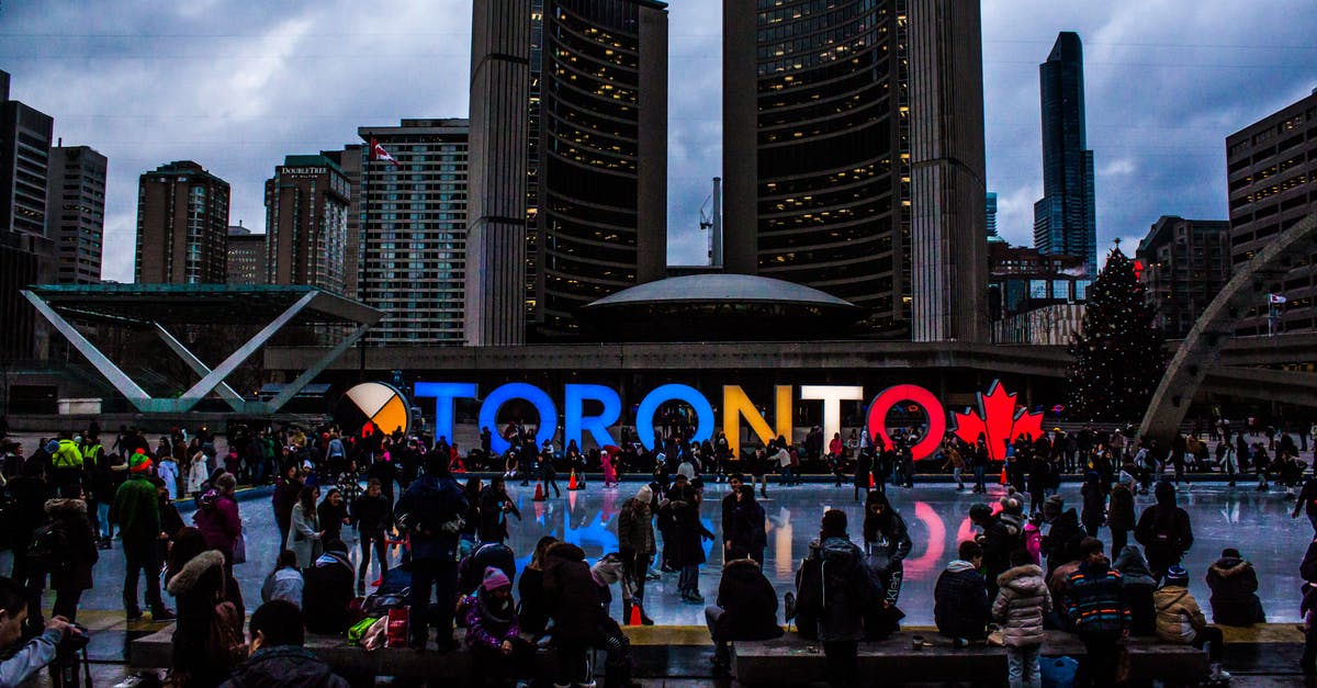 Canada Tourism Visa - How to translate the documents? - People Gathered in Front of Toronto Freestanding Signage