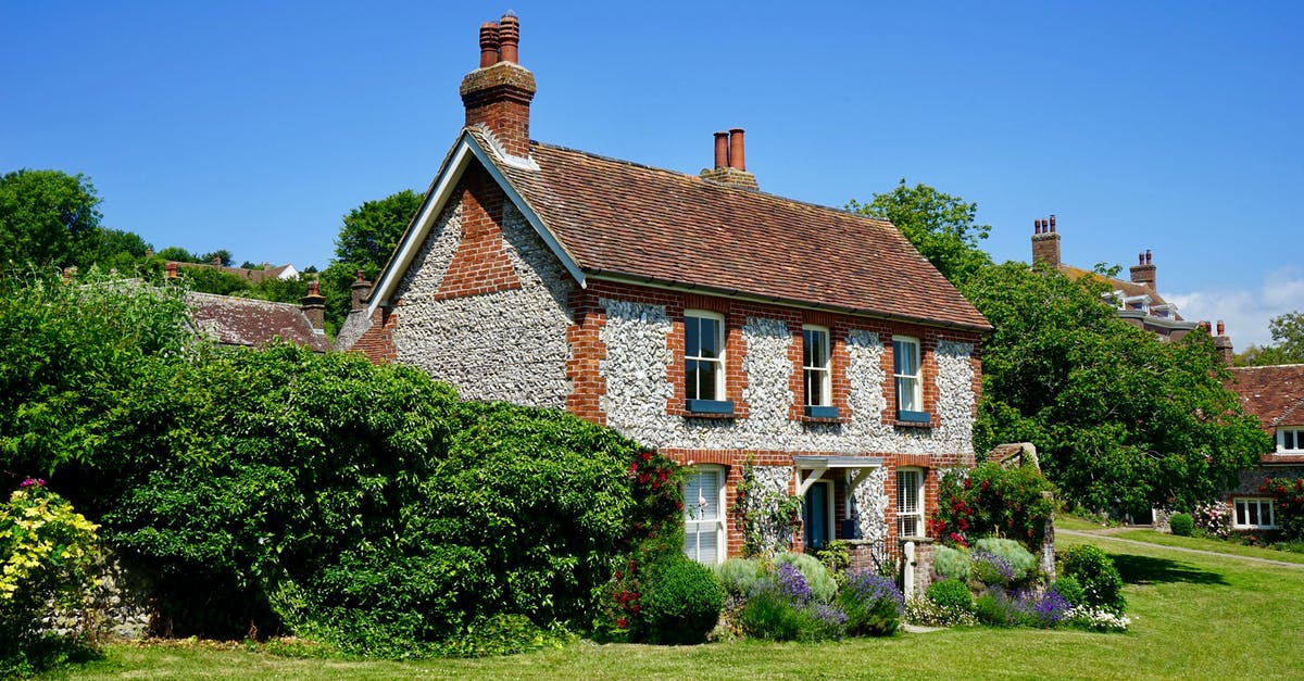 Canada Tourist Visa with few ties to home country - White and Brown Concrete 2-storey House Near Tree