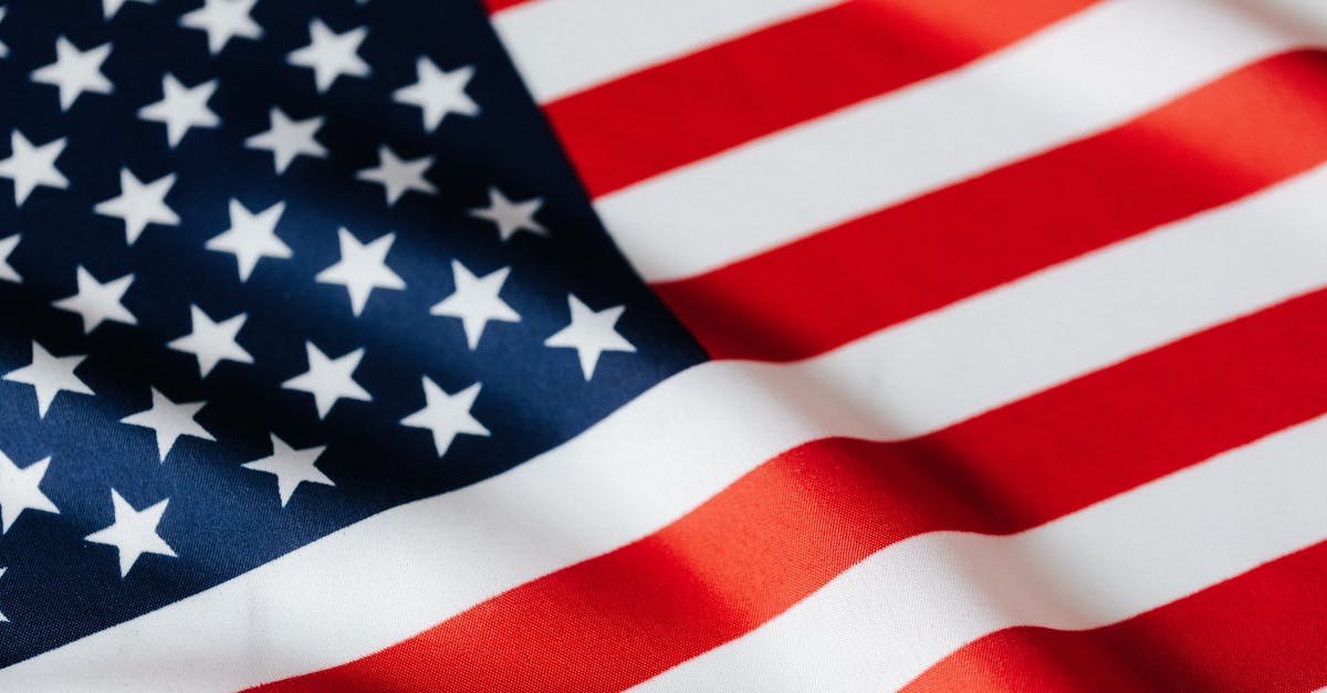 Canadian extended stay in the United States [closed] - From above of closeup flattering national flag of USA with white and red stripes and stars on blue background