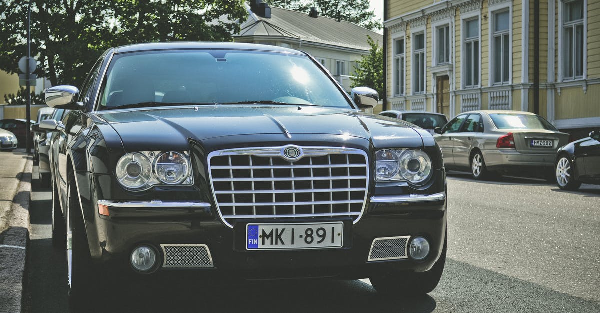 Canadian renting car in Finland and driving sports team members - Black Chrysler 300c Parked on Road