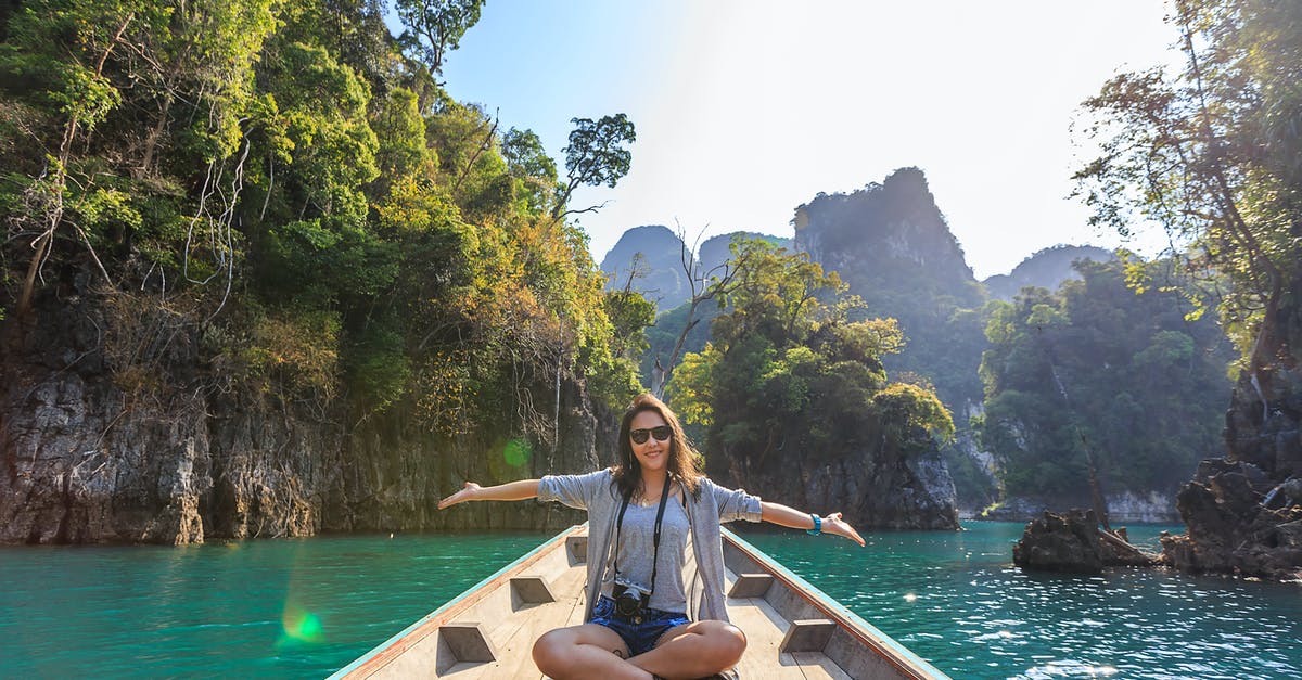 Canadian tourist visa - Photo of Woman Sitting on Boat Spreading Her Arms