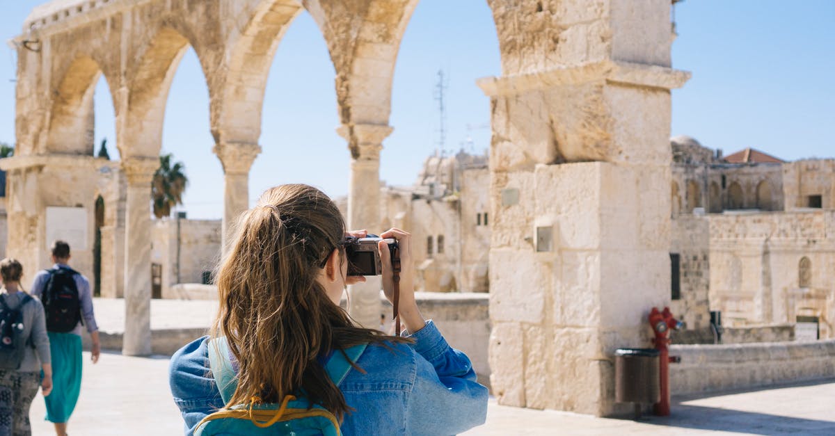 Canadian travelling with Americans to Israel - Woman Taking Pictures of Ruins