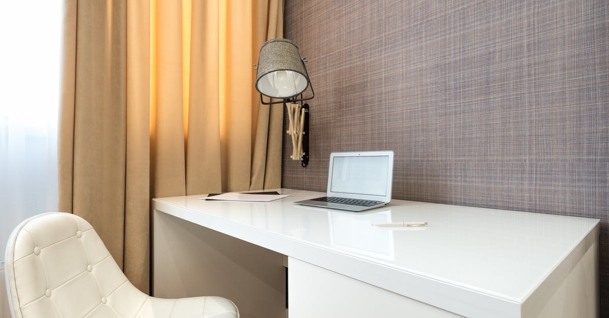 Cancel a Hotel Room After Checking in Online - Interior of hotel room with netbook on table