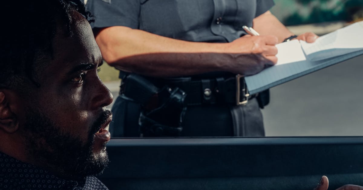 Cancel other person plane ticket that I bought - Man in Black and White Checkered Button Up Shirt Holding White Tablet Computer