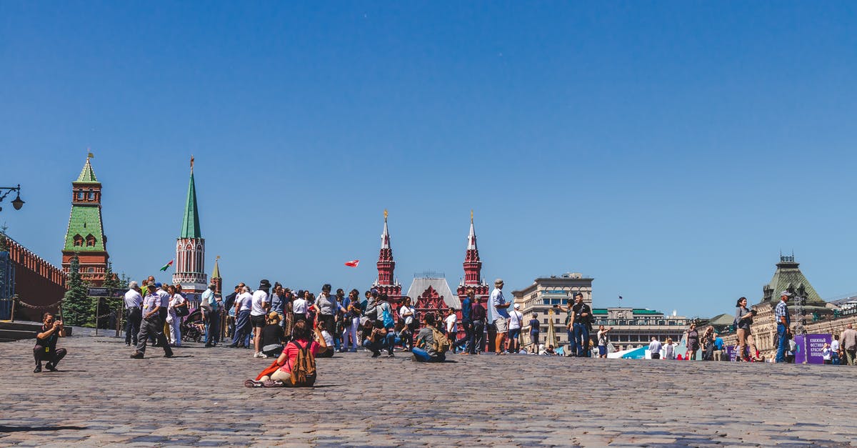 Cancelled unused Russian tourist visa - People Walking On A City Square Under Clear Blue Sky