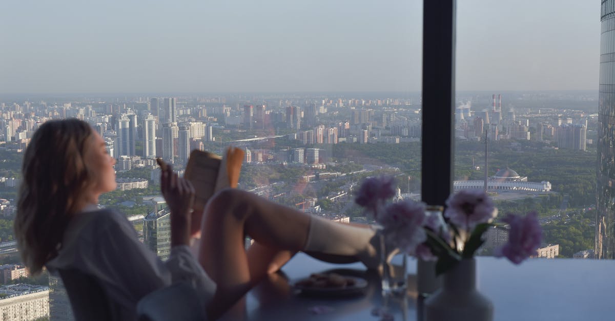 Cancelling apartment booking in Switzerland - Woman in Black Tank Top Sitting on Chair