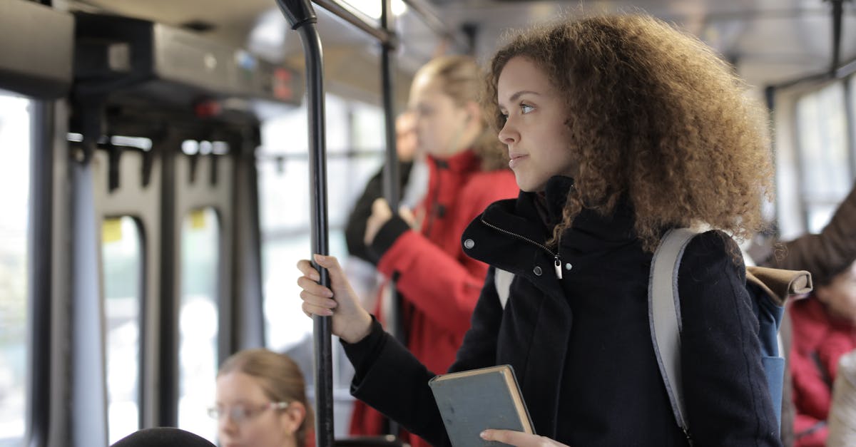 Cancelling only one passenger in a booking - Serious young lady riding bus with book and backpack