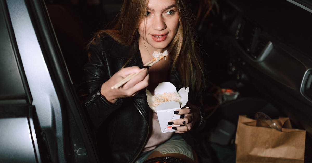 Car Hire Ireland/Wales/England - Woman in Black Leather Jacket Holding Ice Cream Cone