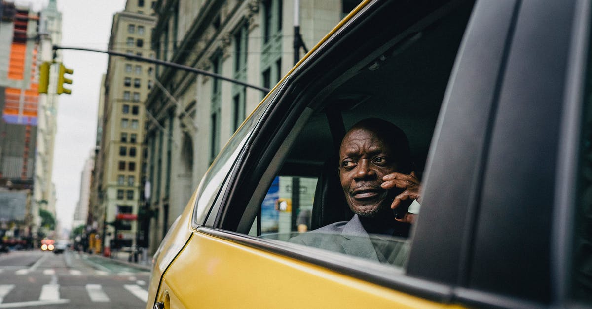 Car hire out of NYC - Man Sitting By The Window Of A Yellow Car