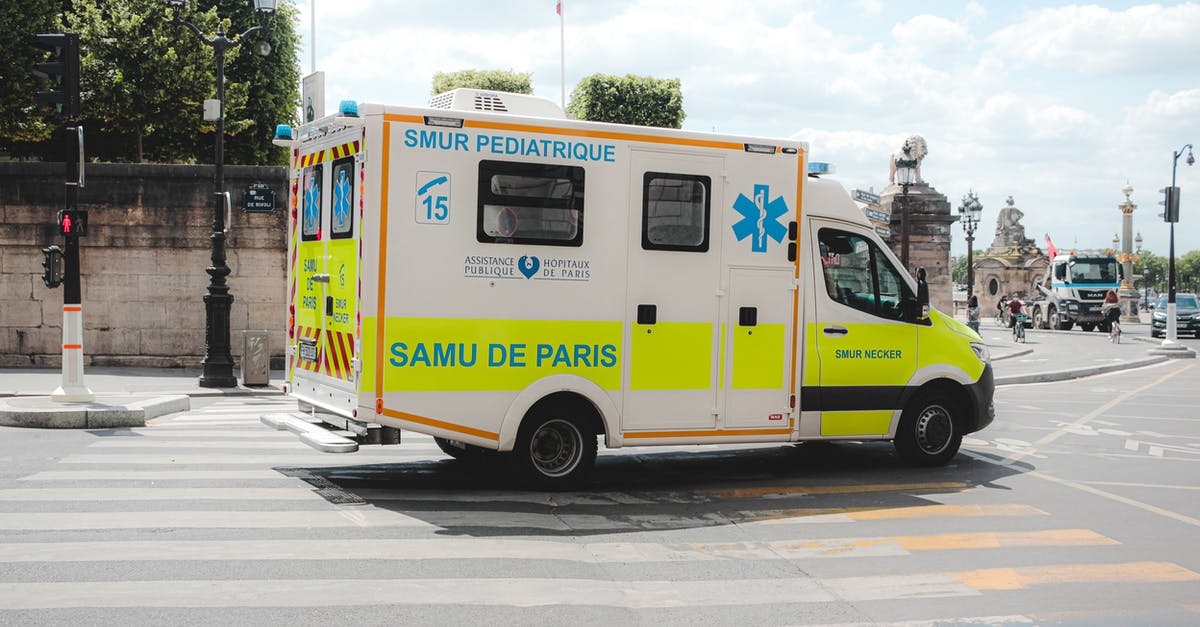 Car insurance in France for 100 days - Ambulance driving along road in sunny city