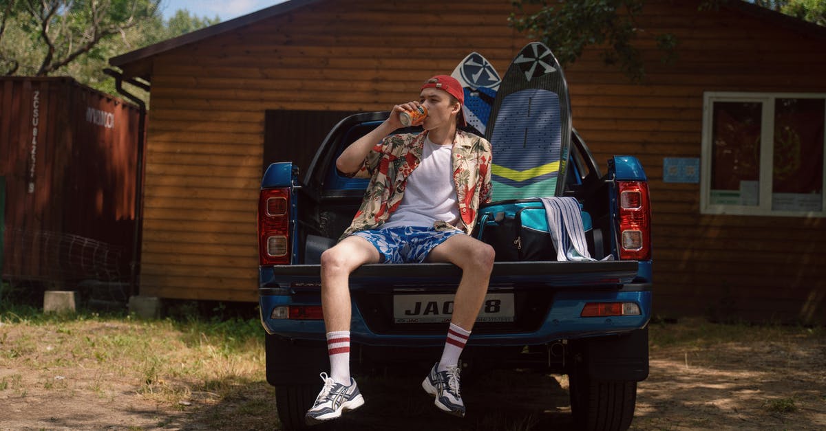 Car pick-up points in Rome - Teeanage Boy Sitting on Car Trunk and Drinking Mirinda