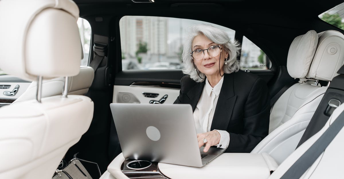 Car rental at 20 years old in UK - Woman in Black Suit Sitting on Car Seat