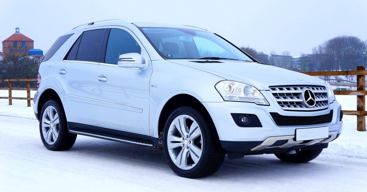 Car rental cancellation because of lack of winter tires - White Mercedes-benz Suv Parked Beside Brown Wooden Fence