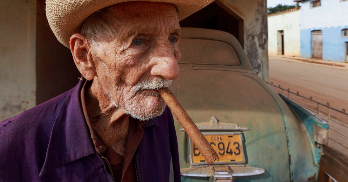 Car rental in Cuba - Man Wearing a Farmers Hat Smoking Cigar