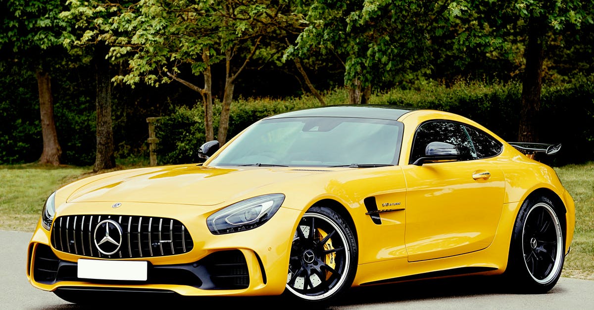 Car rental in Ireland for under-25 driver - Yellow Mercedes-benz Beside Trees