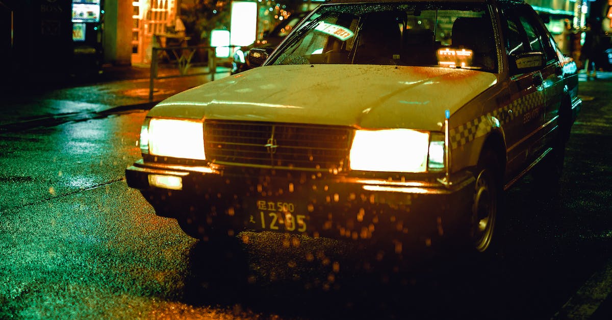 Car rental in Japan - White Sedan during Nighttime