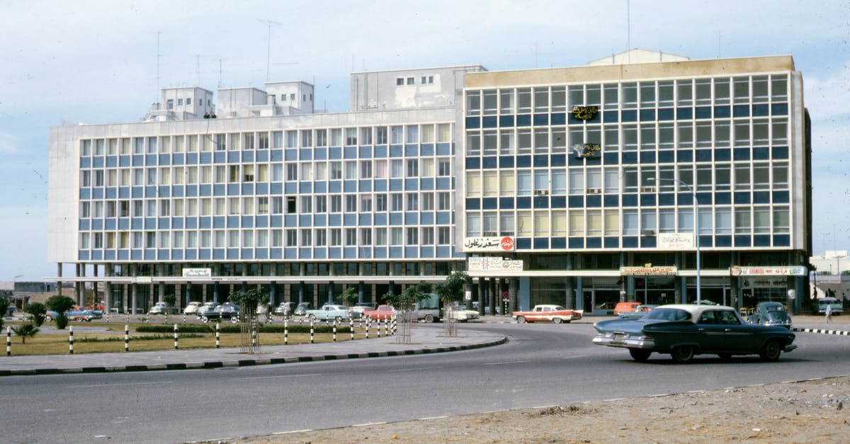 Car Seats in Saudi Arabia - Old Photo of White Concrete Building 