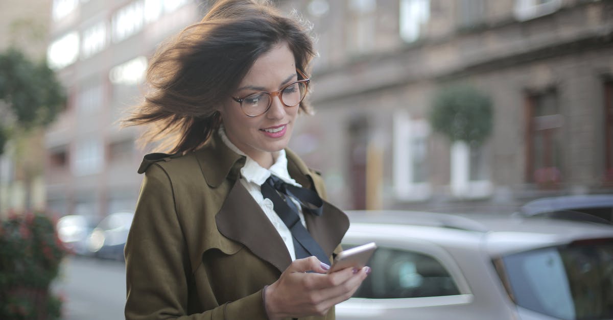 Car share in Las Vegas? - Stylish adult female using smartphone on street