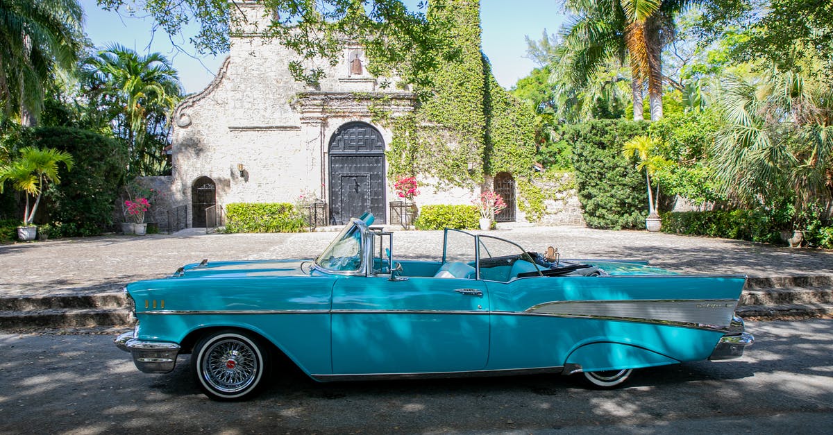 Caribbean Travel from Miami to Nassau to Santiago de Cuba - Blue Vintage Car Parked Beside Green Trees