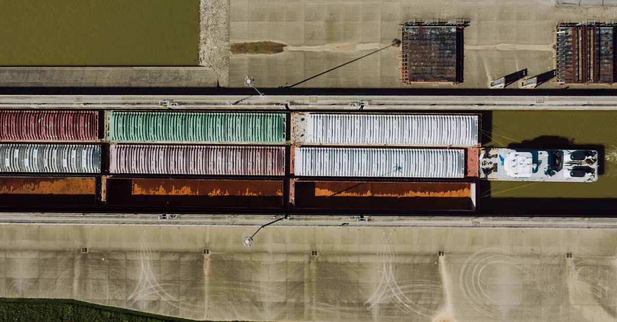 Carry a drone during a Dubai/Seychelles trip - Barge traffic with containers on water channel