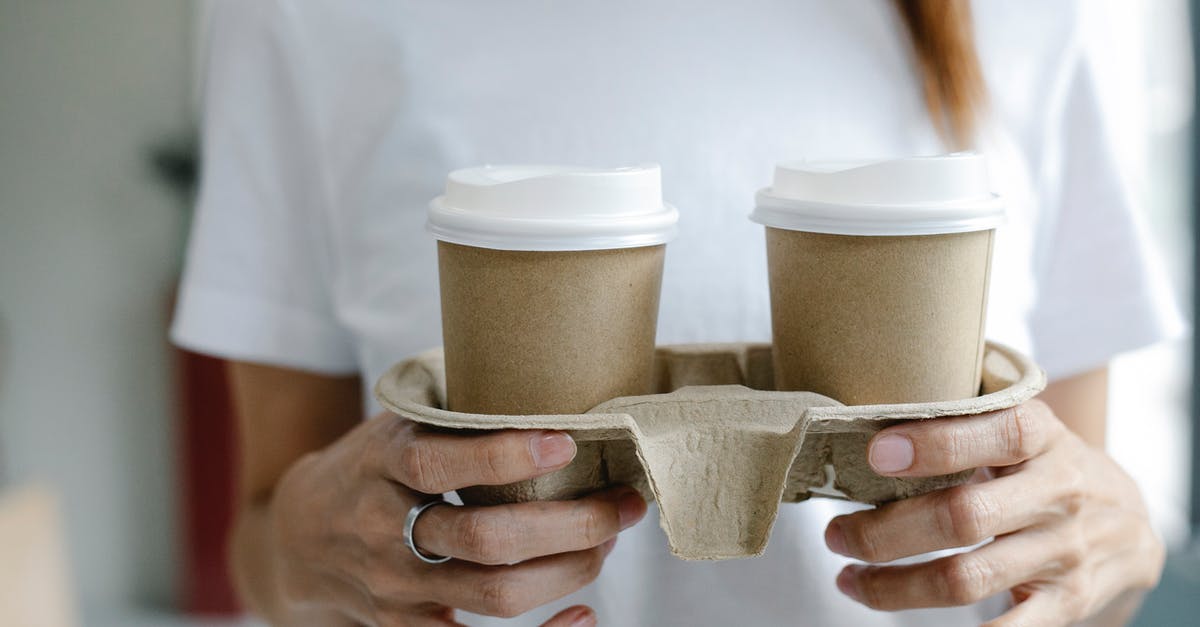 Carry domestic currency while going abroad [duplicate] - Crop woman with coffee to go