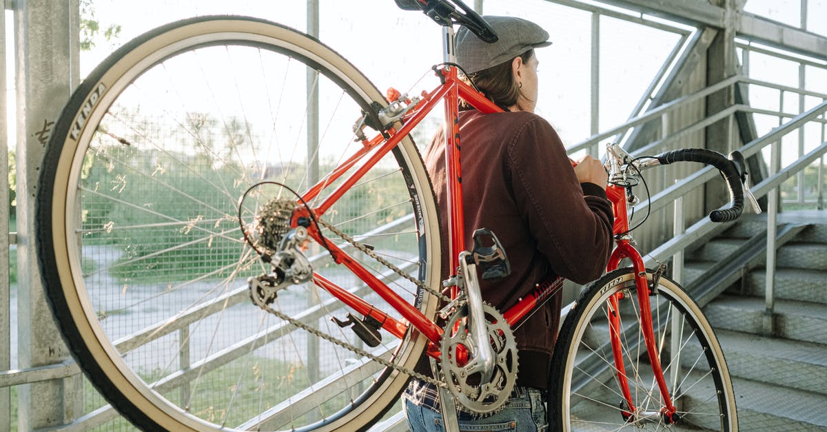 Carrying a Cargo Bike in European Trains? - A Man Carrying a Bicycle