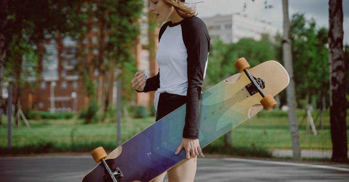 Carrying a longboard on a Germanwings-Eurowings flight - Selective Focus Photo of a Woman Carrying a Longboard