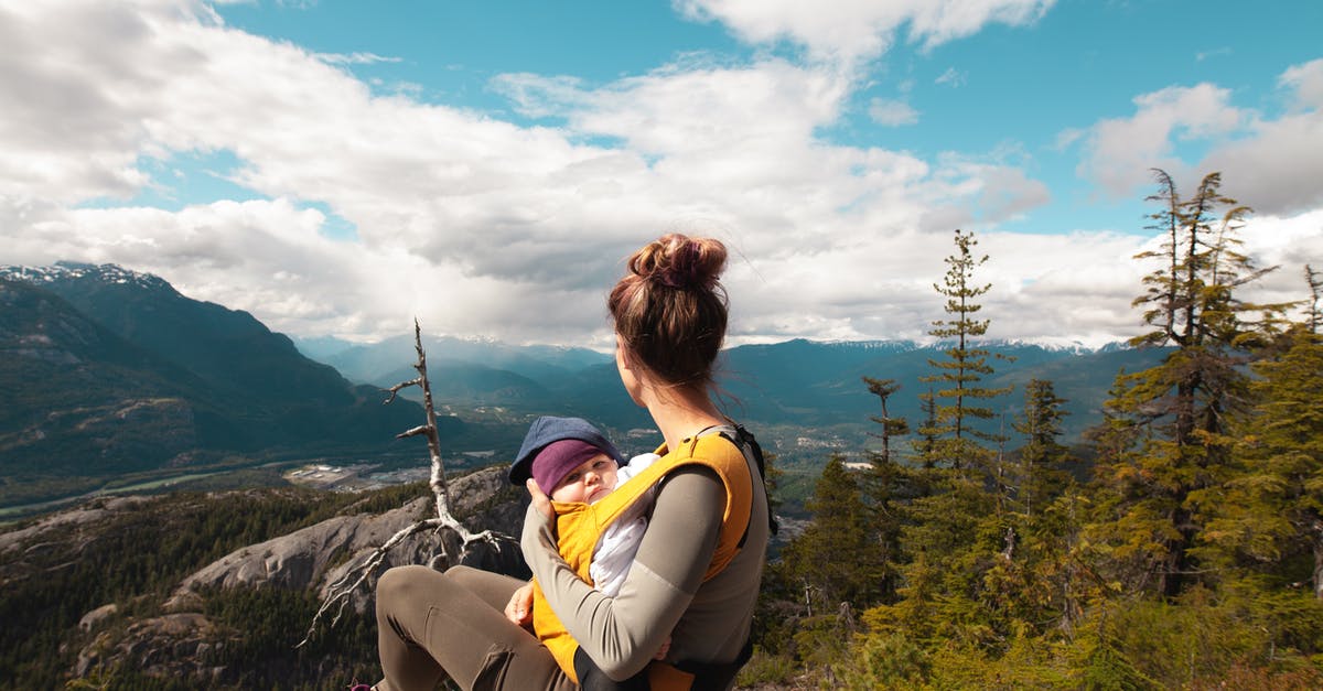 Carrying Condoms while traveling to Dubai - Mother Carrying Her Baby while Looking at the Nature Scenery