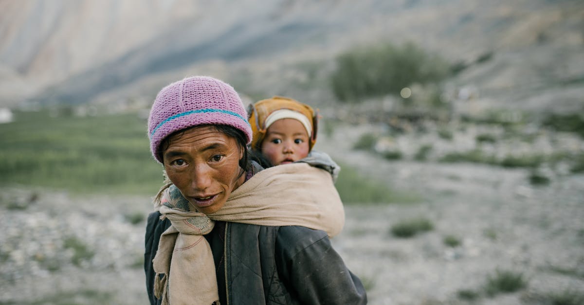 Carrying Exhibition items From India to Dubai & Back - Woman Carrying a Child on Her Back