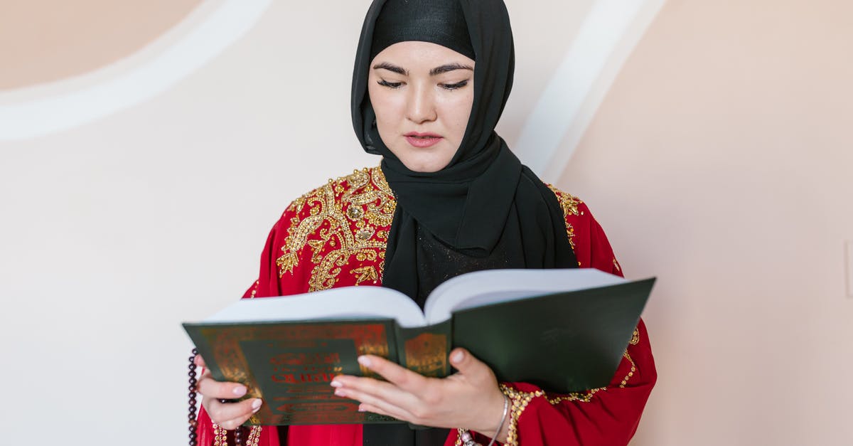 Carrying Exhibition items From India to Dubai & Back - Woman in Black Hijab Holding Book