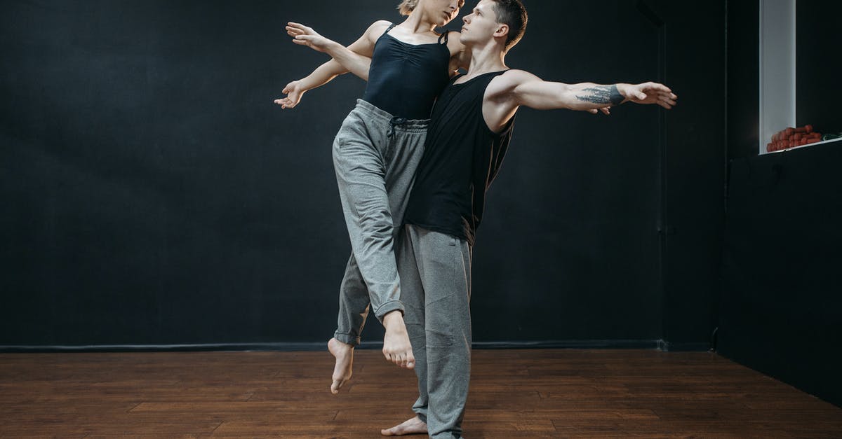 Carrying items for other people in my baggage - A Man and Woman Looking at Each Other while Dancing