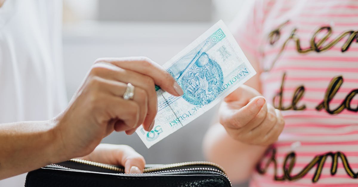 Cash allowance while transiting through Zurich - Person Holding a 50 Polish Zloty Bill