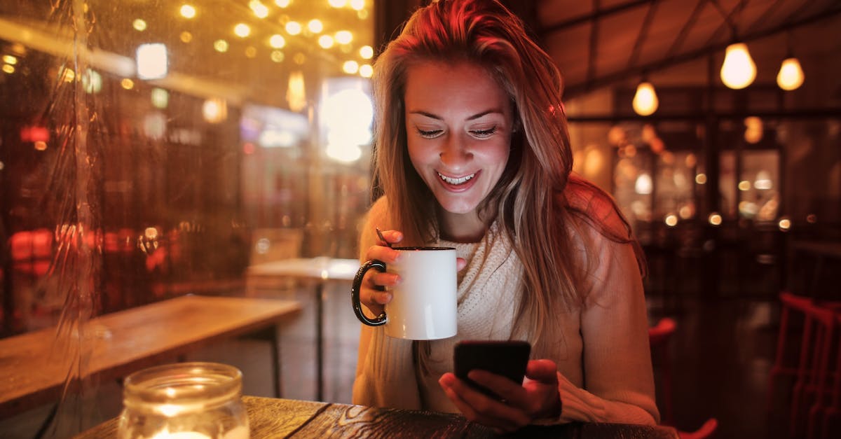 Casual restaurant recommendations in Buenos Aires [closed] - Woman Holding White Ceramic Mug Looking at Her Cellphone