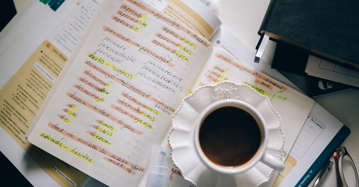 Catalan or Spanish in Barcelona? - A Cup of Black Coffee on a Notebook with Notes of Foreign Language with Translation