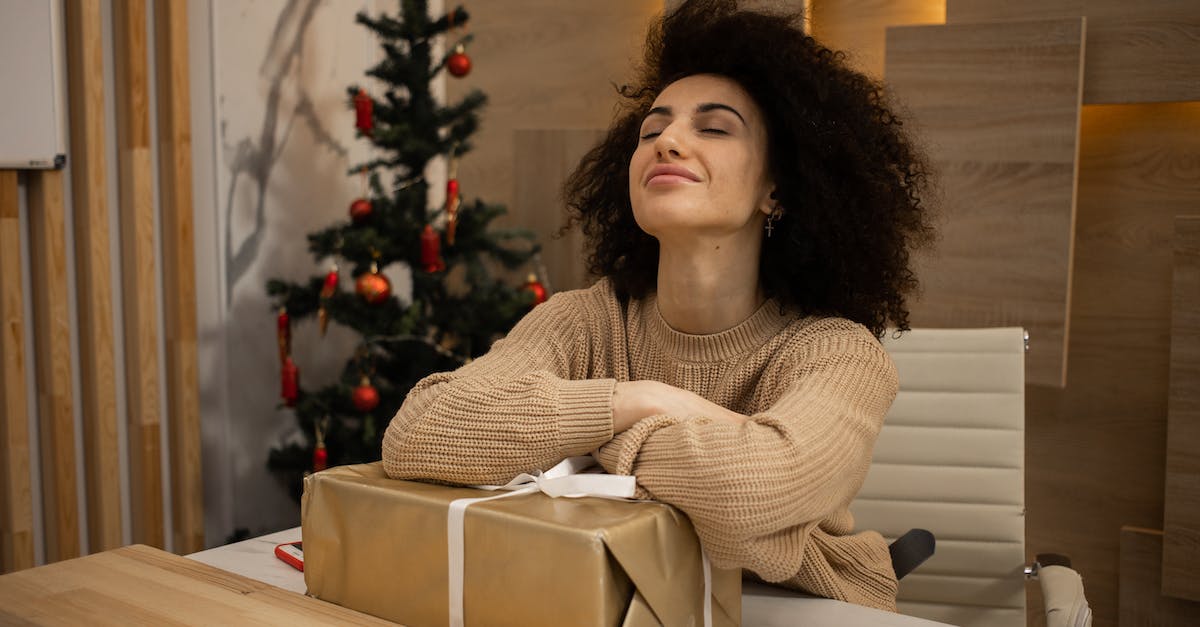 Celebrating Christmas in Bethlehem, Palestine - Happy Woman Sitting at Desk with Present