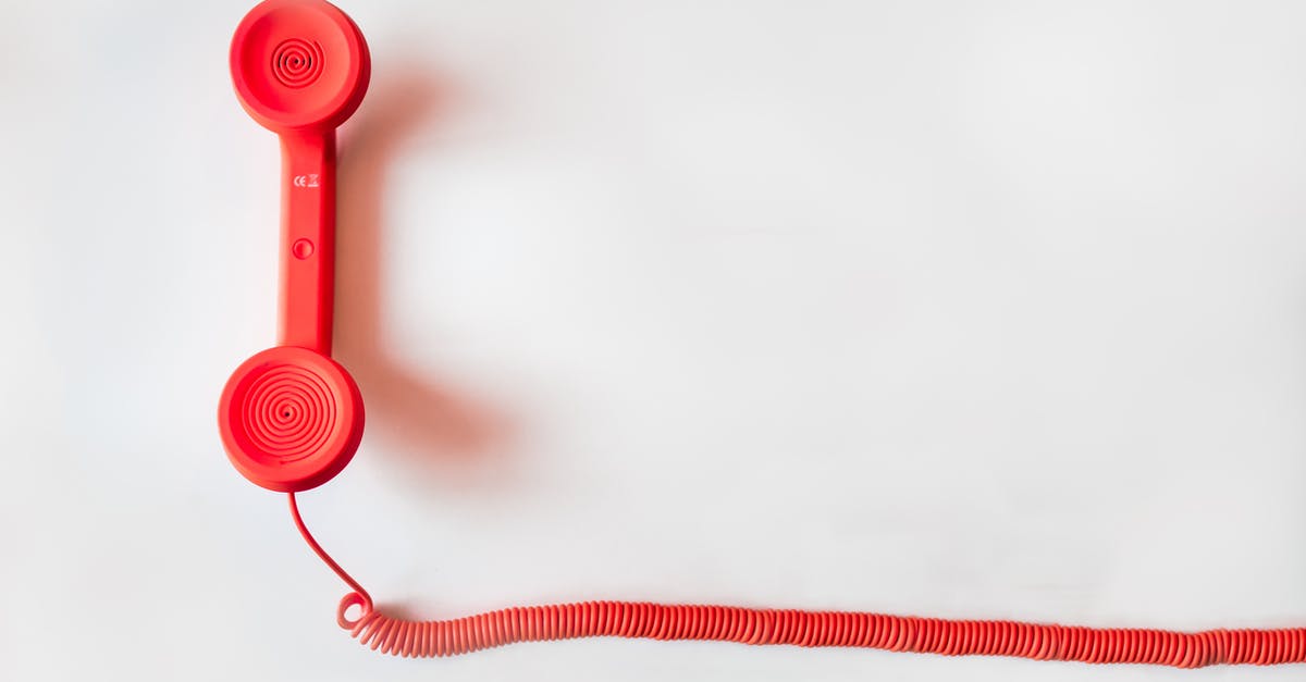 Cell phone service providers in France with English customer support - Red Corded Telephone on White Suraface