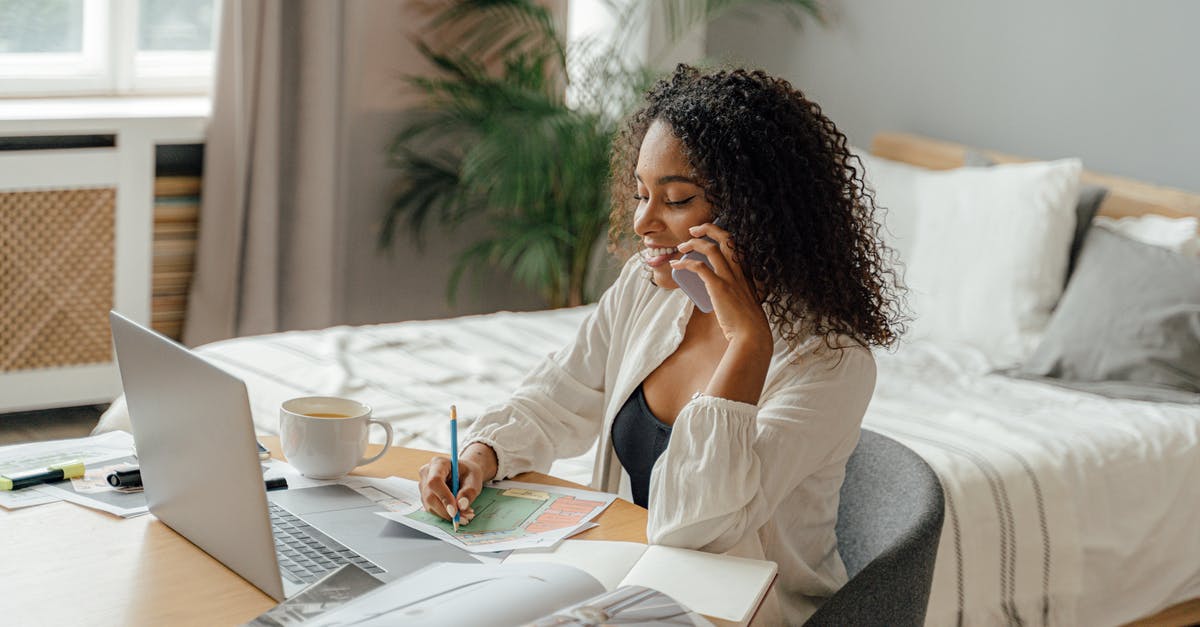 Cellphone carriers in Europe - Woman in White Long Sleeve Shirt Sitting on Gray Couch