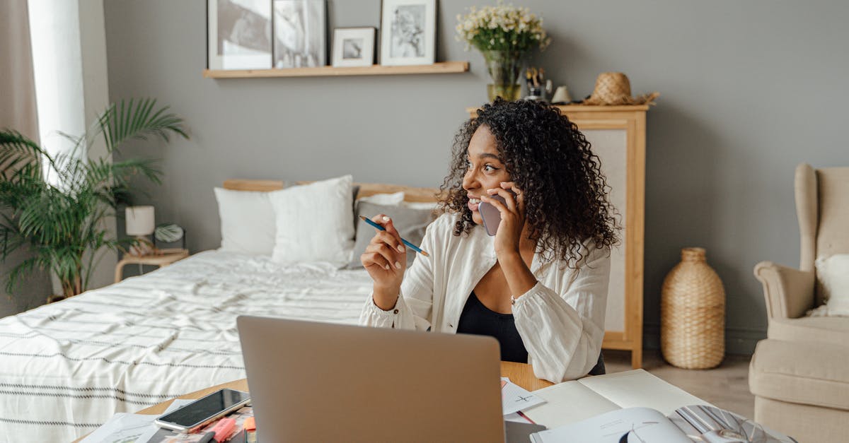 Cellphone carriers in Europe - Woman in White Long Sleeve Shirt Sitting on Chair