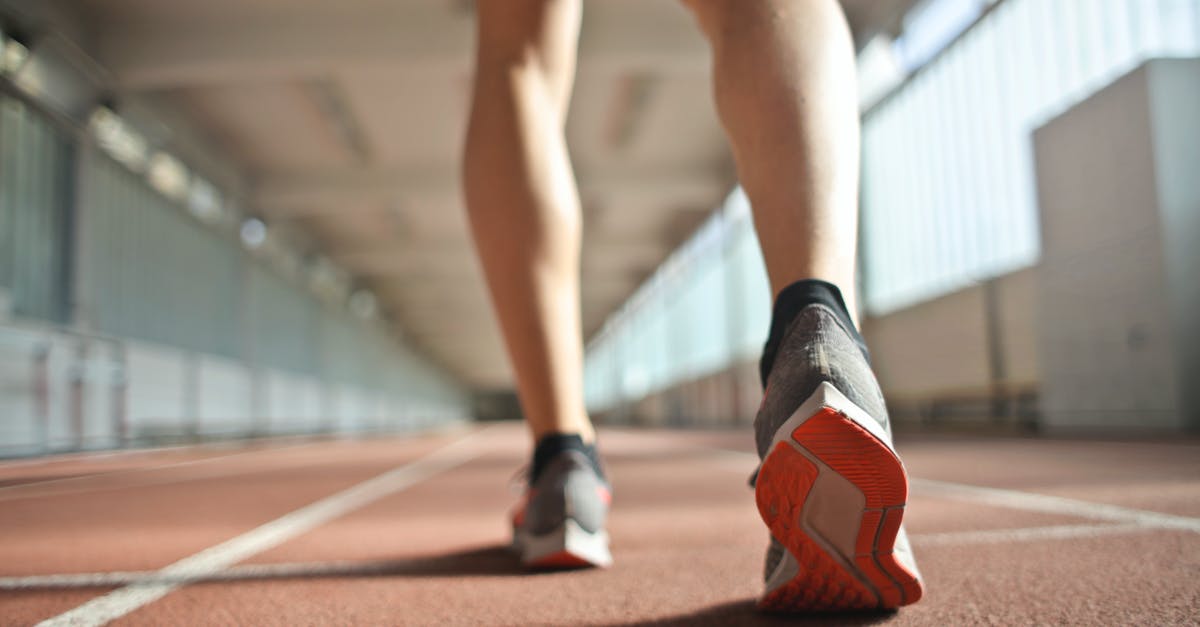 Ceuta to Tangier by foot and train? - Fit runner standing on racetrack in athletics arena