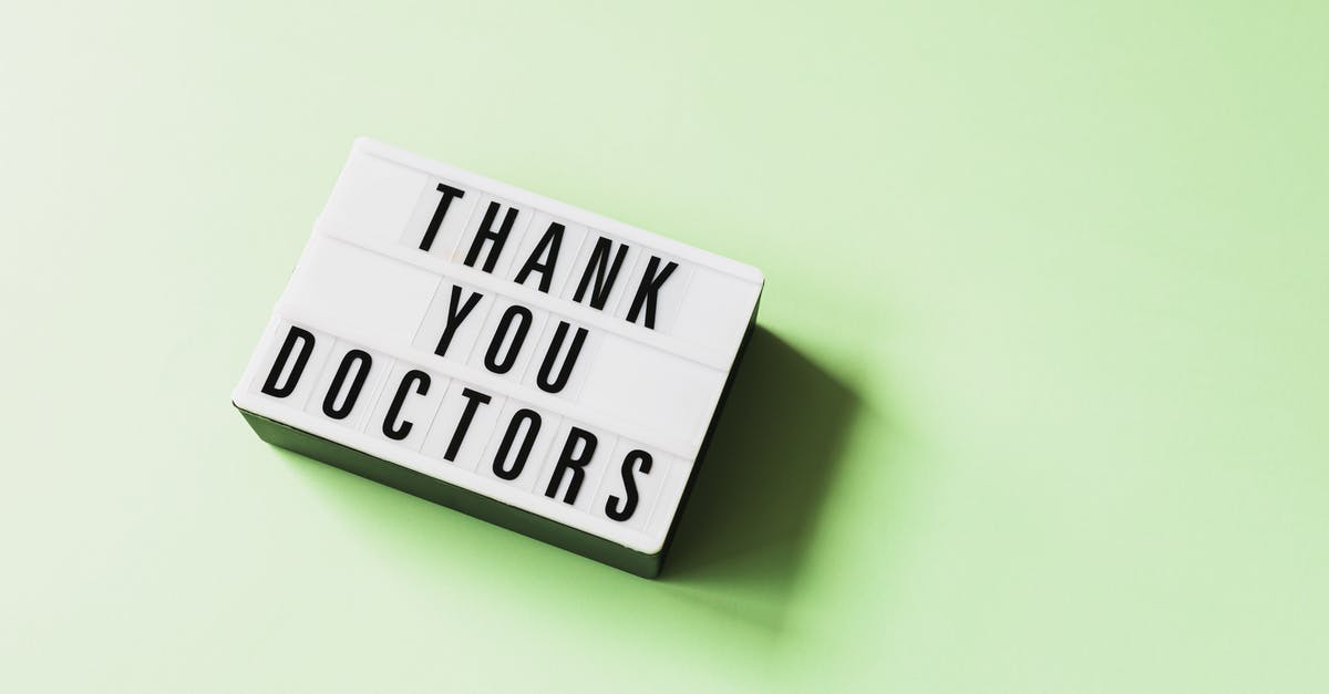 Change of Occupation Notice - From above of vintage light box with THANK YOU DOCTORS inscription placed on green surface